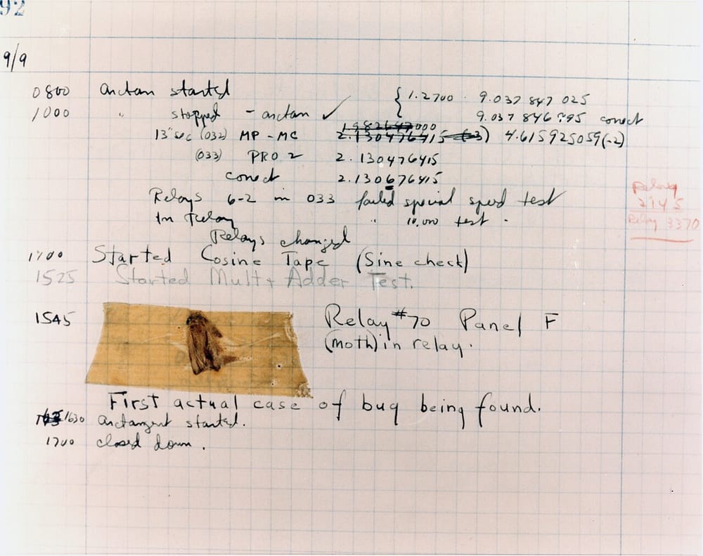 A page of a logbook dated 9/9, full of handwritten times and notes. A dead moth is taped to the page, above the words: First actual case of bug being found.