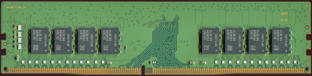 A memory module: a green board with eight black memory chips in a row, and gold contacts along its bottom edge.