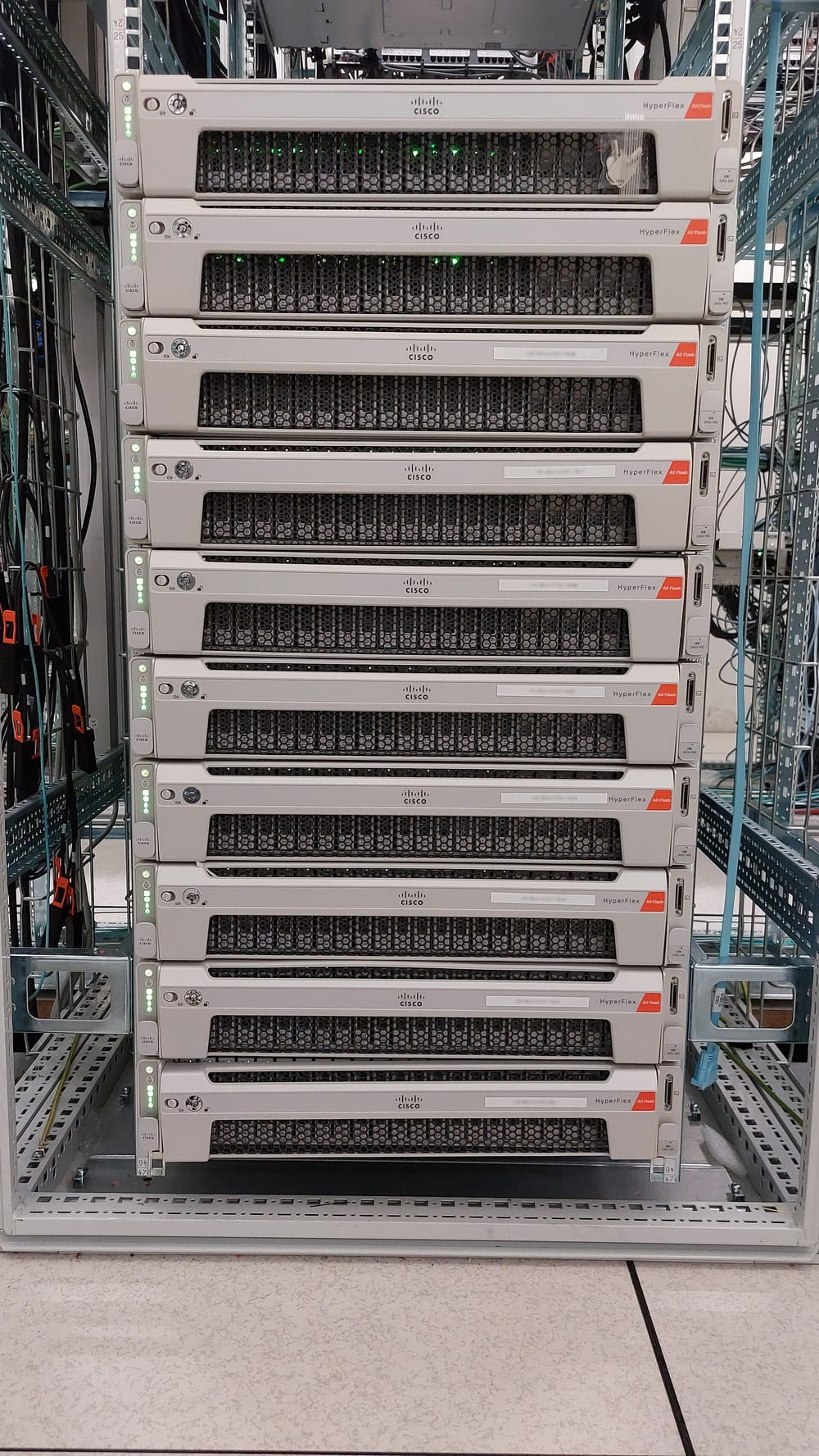 A metal rack frame holding ten flat, wide server computers, stacked one above another.